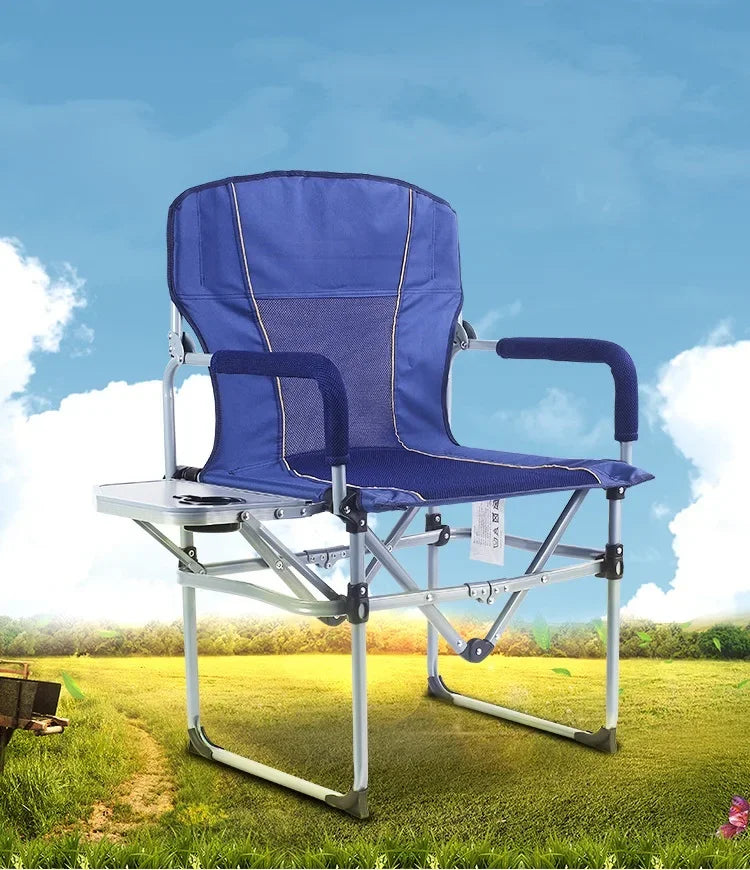 Blue camping chair with adjustable armrests on a grassy field with a blue sky.