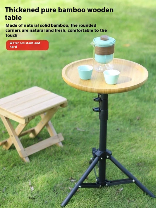Bamboo table with a stool on grass, featuring text about the material and features.