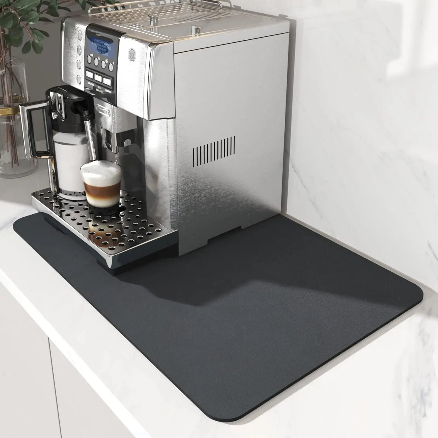 Espresso machine on a kitchen counter with a black spill mat underneath