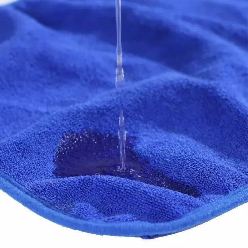 Blue towel with water droplets being poured onto it