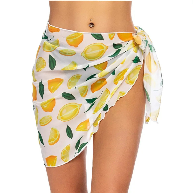 White sarong with lemon pattern worn by a person on a white background