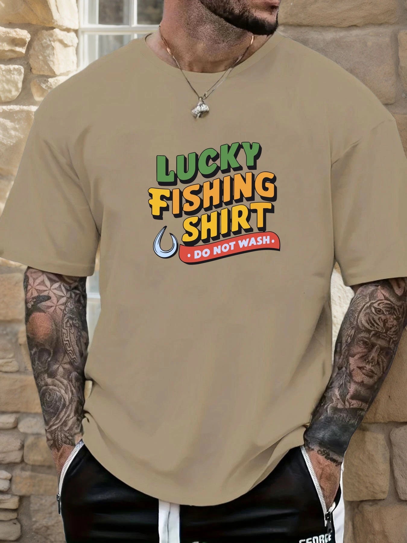 Person wearing a beige t-shirt with 'Lucky Fishing Shirt Do Not Wash' text and graphics.