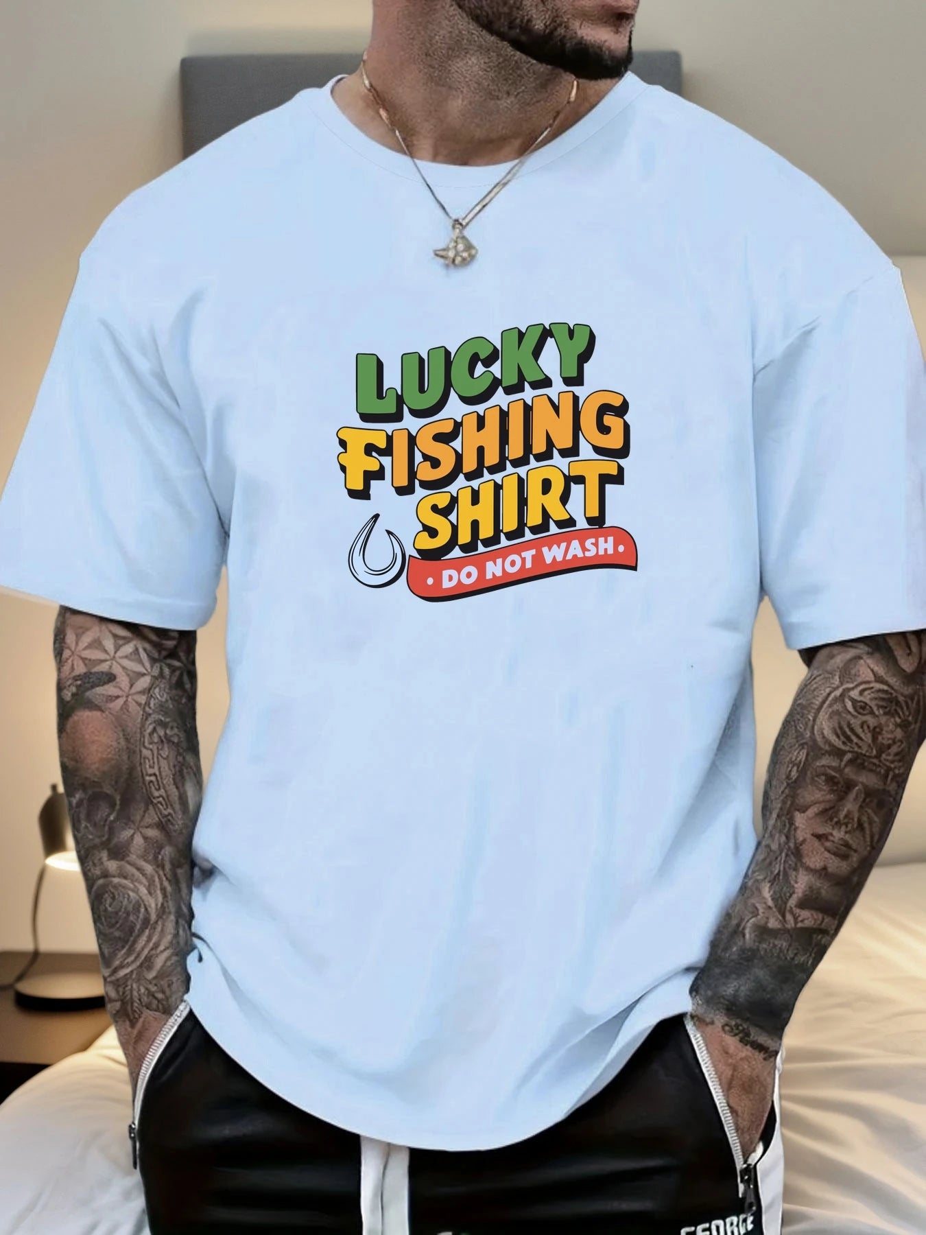 Person wearing a light blue t-shirt with 'Lucky Fishing Shirt Do Not Wash' text and graphics.