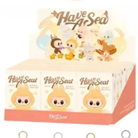 Cute labubu packaging with 'Have a Seat' branding, including keychains and boxes.