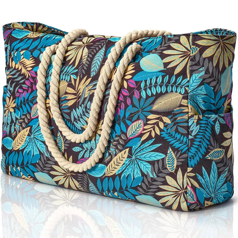 Tropical leaf patterned bag with rope handles on a white background