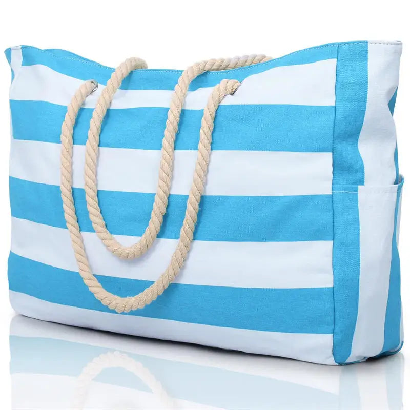 Blue and white striped tote bag with rope handles on a reflective surface