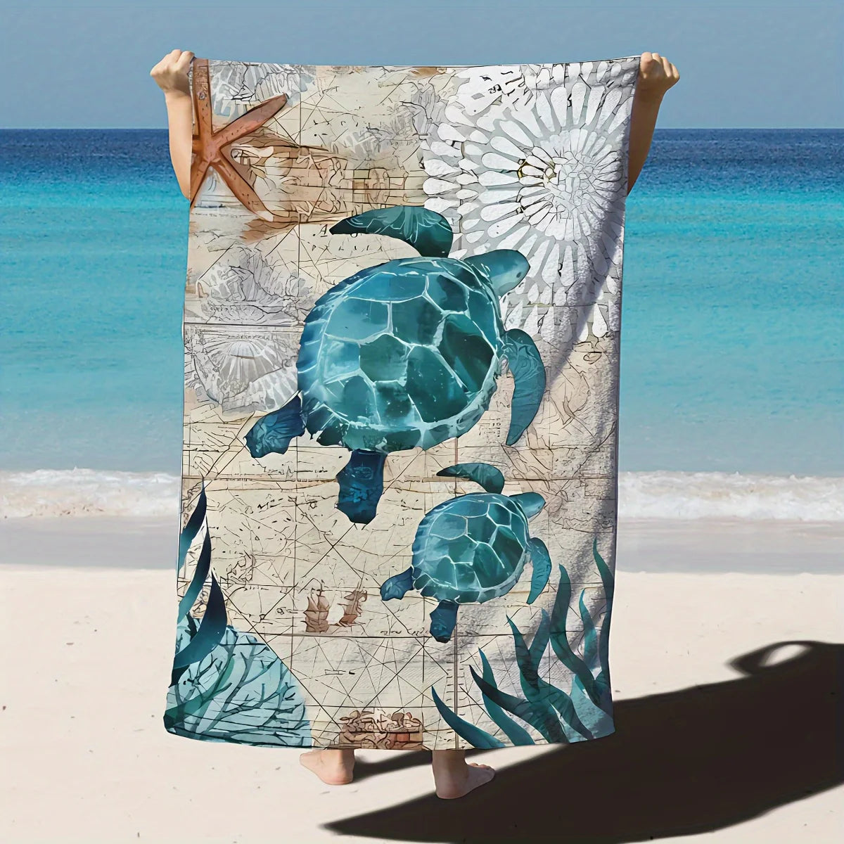 Towel with turtle design held up against a beach background