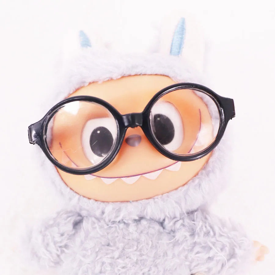 Cartoonish character with googly eyes and glasses on a white background