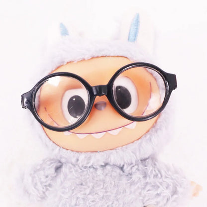 Cartoonish character with googly eyes and glasses on a white background