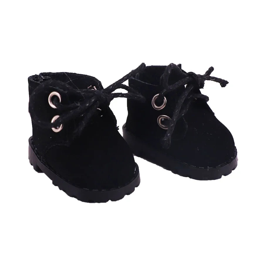 Pair of black suede boots with eyelets on a white background