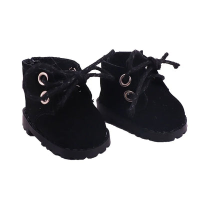 Pair of black suede boots with eyelets on a white background
