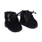 Pair of black suede boots with eyelets on a white background