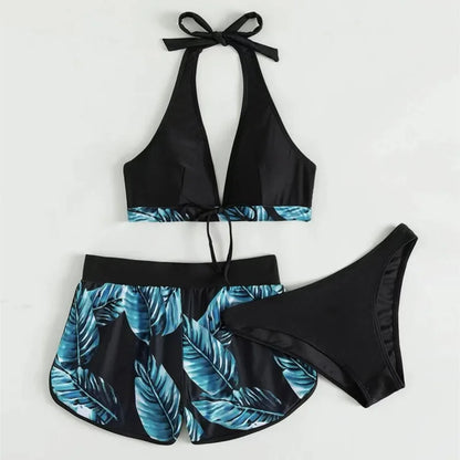 Black and blue leaf-patterned bikini set on a white background