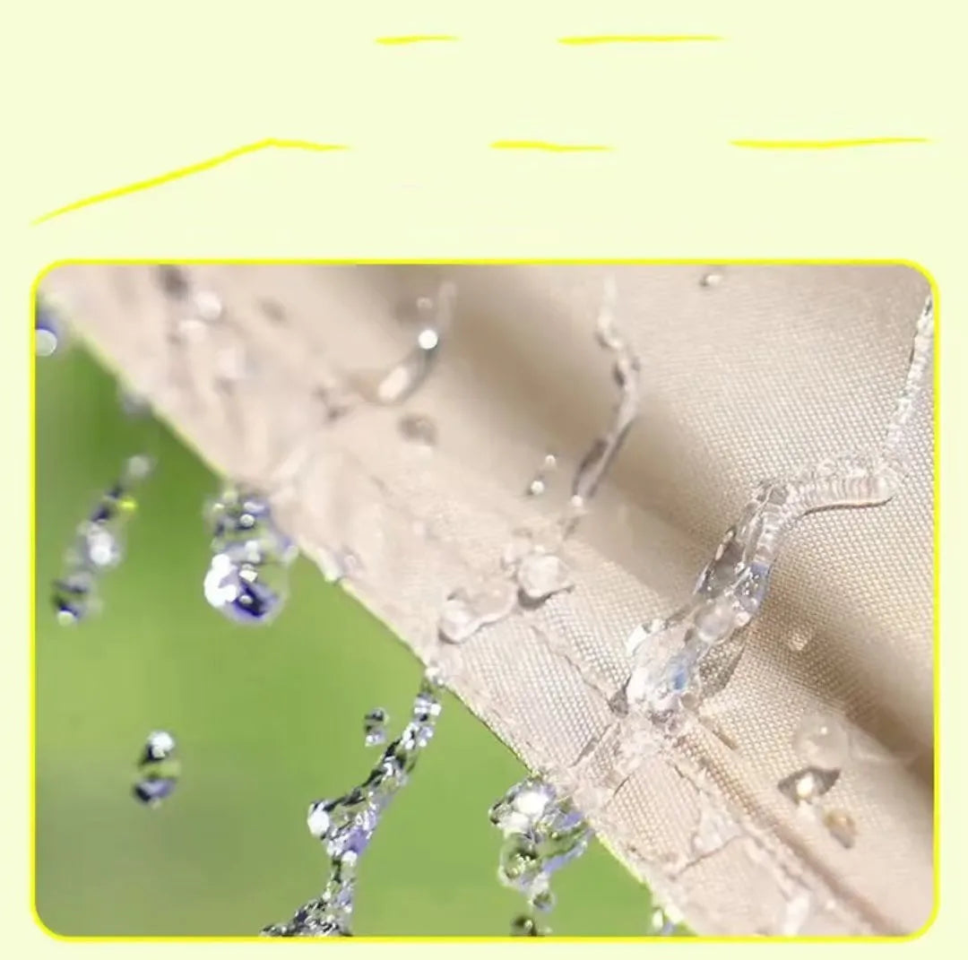 Close-up of water droplets on a fabric surface with a green blurred background