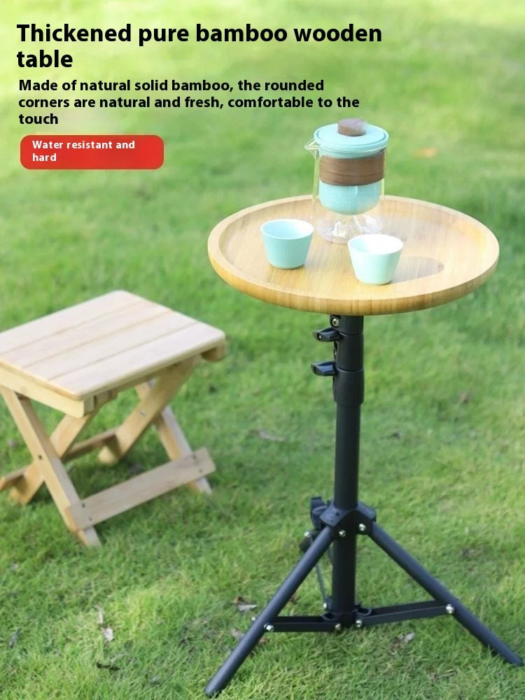 Bamboo table with a stool on grass, featuring text about the material and features.