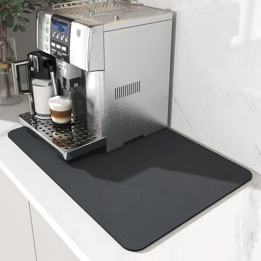 Espresso machine on a kitchen counter with a black spill mat underneath
