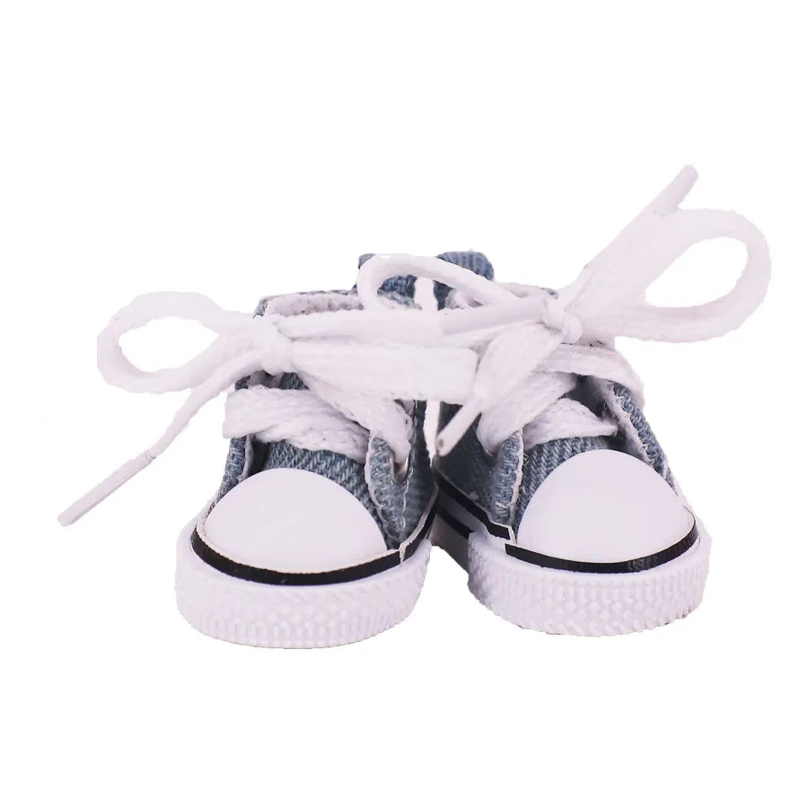 Pair of denim shoes with white laces on a white background