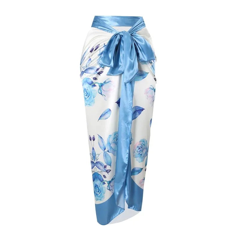 Floral patterned sarong with a blue ribbon on a white background