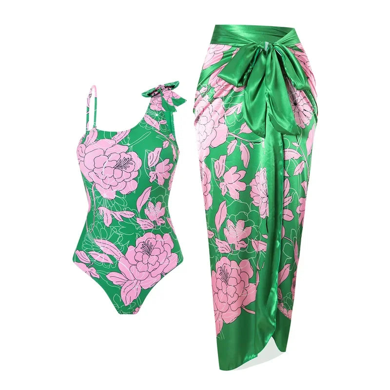 Green and pink floral swimsuit with matching sarong on a white background