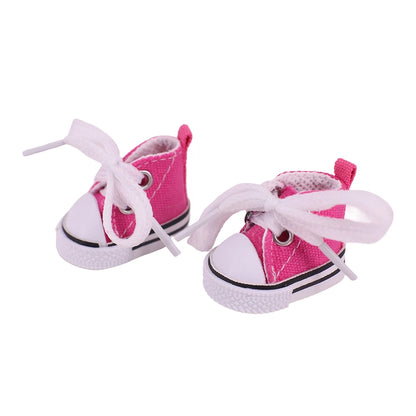 Pair of pink sneakers with white laces on a white background