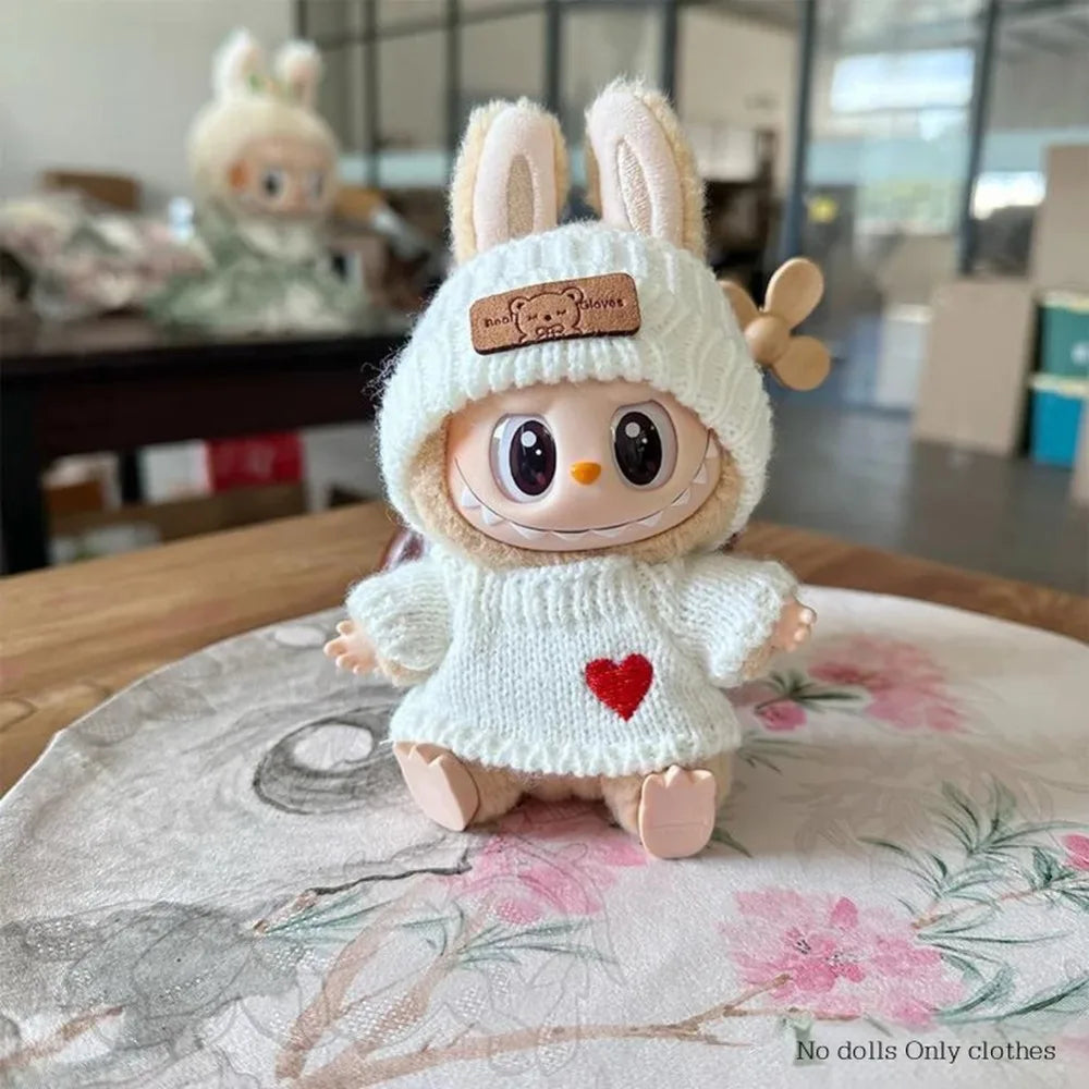 Toy figure wearing a white sweater with a red heart on a floral surface
