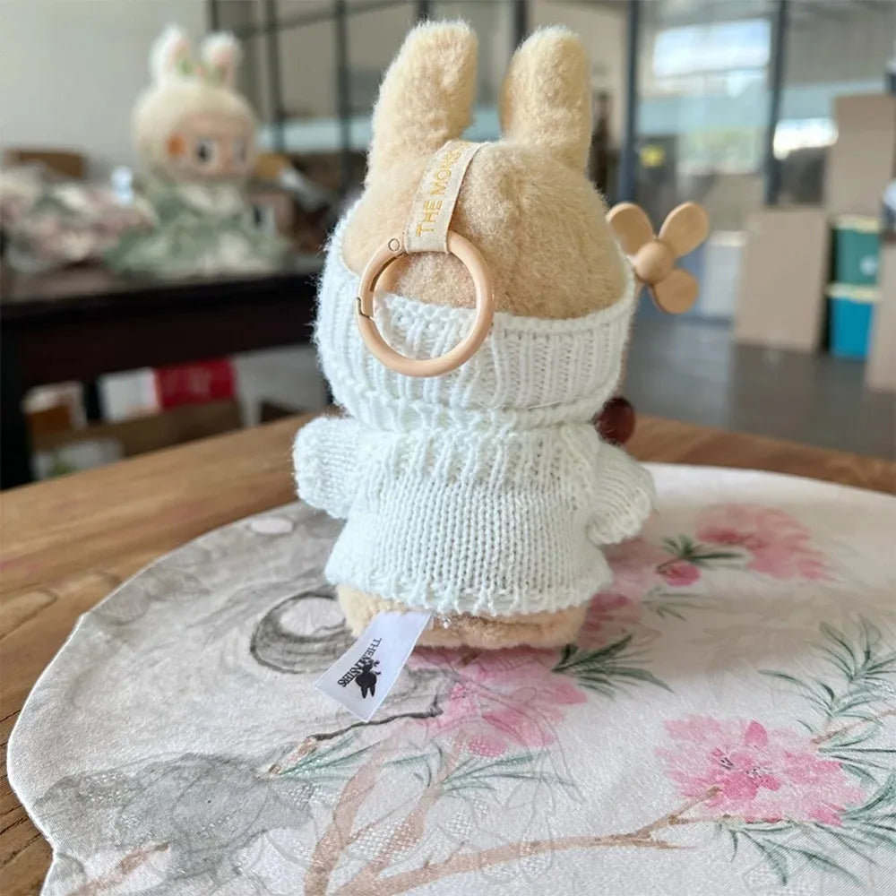 Plush toy with a wooden ring on a floral surface