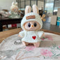 labubu wearing a white knit sweater with a red heart on a floral-patterned surface.