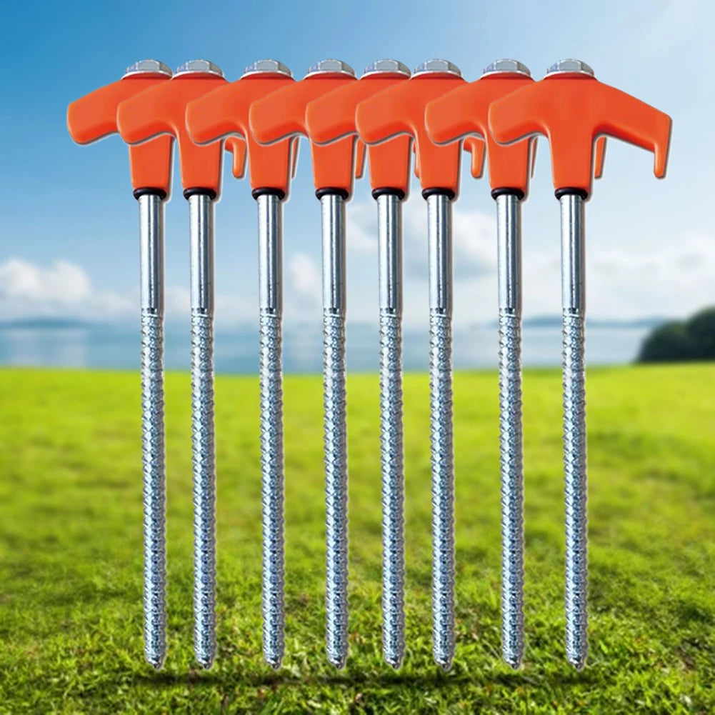 Set of orange-handled stakes with metal shafts on a grassy field with a blue sky.
