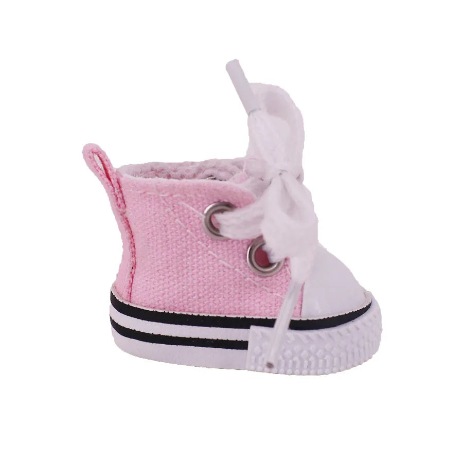 Pink baby shoe with white laces on a white background