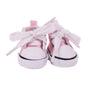 Pink baby sneakers with white laces on a white background
