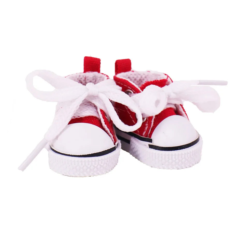 Red and white baby shoes with white laces on a white background