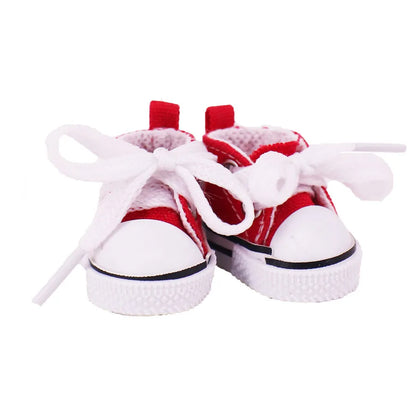 Red and white baby shoes with white laces on a white background