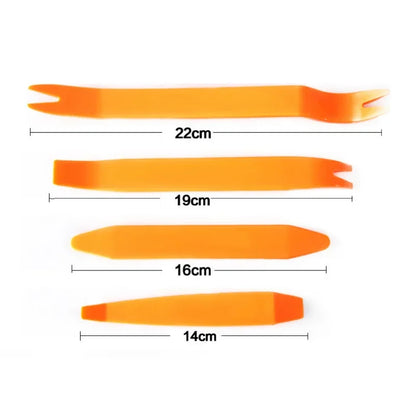 Set of orange plastic tools with measurements on a white background